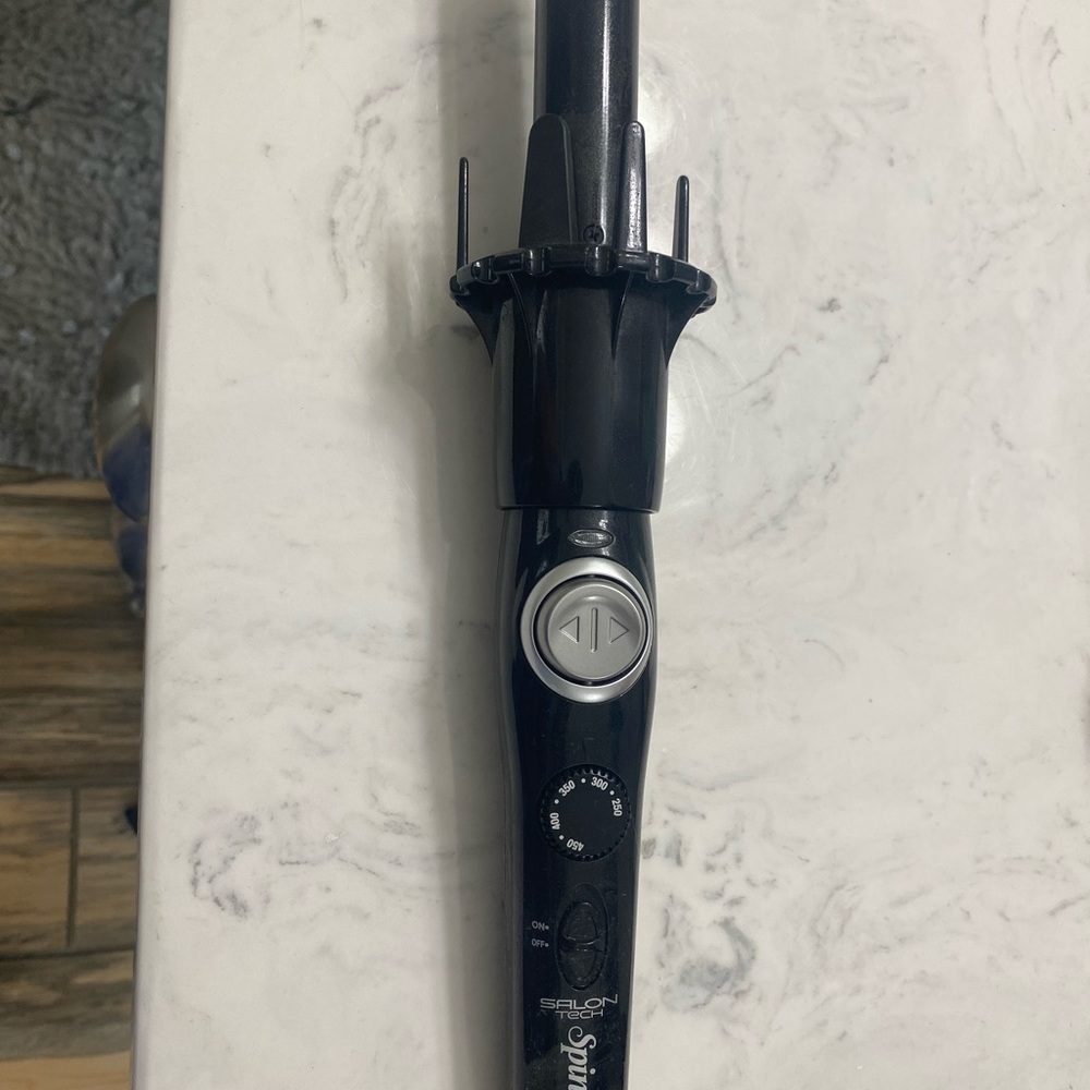 Spin style curling iron